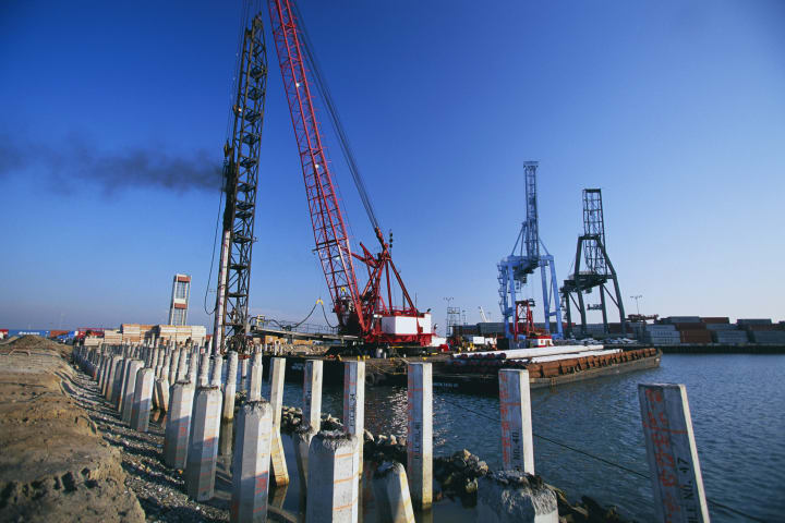 A pile-driving apparatus hammers bridge-supporting posts into the seabed in the Port of Long Beach, California.
