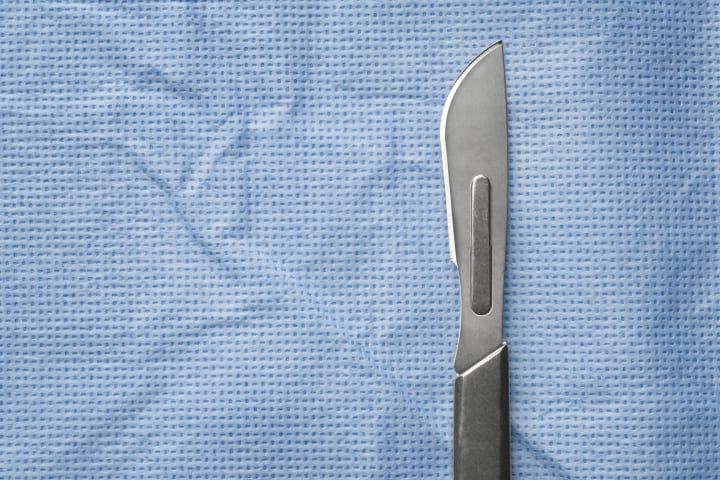 Scalpel on surgical fabric