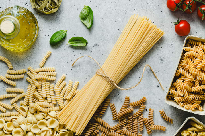 Pasta shapes like spaghetti and rotini are depicted. 