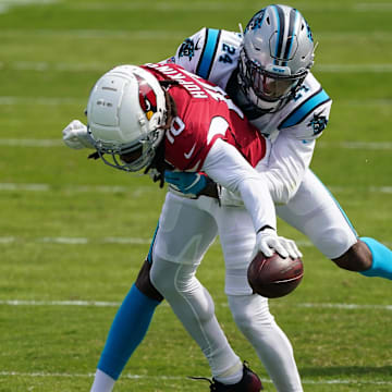 Oct 4, 2020; Charlotte, North Carolina, USA; Carolina Panthers cornerback Rasul Douglas (24) tackles Arizona Cardinals wide receiver DeAndre Hopkins (10) during the second quarter at Bank of America Stadium. Mandatory Credit: Jim Dedmon-Imagn Images