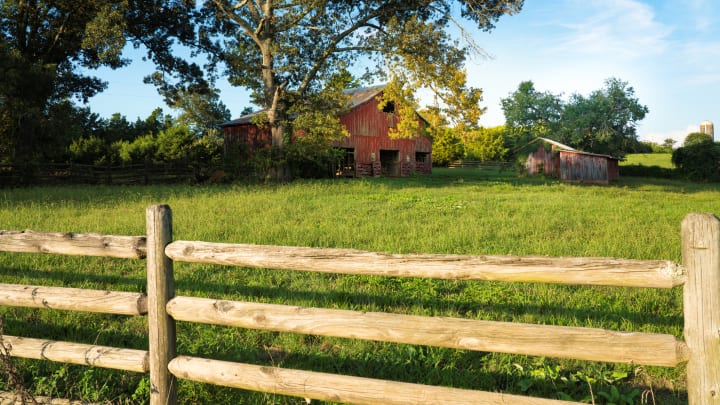 old-fashioned red barn and wooden fence