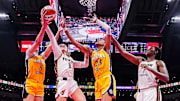 Indiana Fever guard Sophie Cunningham goes up for a basket against Los Angeles Sparks forward Dearica Hamby and Los Angeles Sparks forward Azura Stevens.