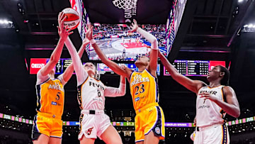 Indiana Fever guard Sophie Cunningham goes up for a basket against Los Angeles Sparks forward Dearica Hamby and Los Angeles Sparks forward Azura Stevens.