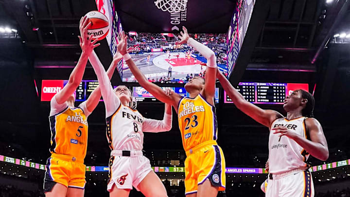 Indiana Fever guard Sophie Cunningham goes up for a basket against Los Angeles Sparks forward Dearica Hamby and Los Angeles Sparks forward Azura Stevens. Indiana Fever guard Sophie Cunningham goes up for a basket against Los Angeles Sparks forward Dearica Hamby and Los Angeles Sparks forward Azura Stevens.