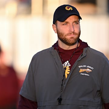 Walsh Jesuit football coach Nick Alexander looks on during warmups as the Warriors played St. Vincent-St. Mary on Friday, Oct. 21, 2022.