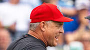 Jun 15, 2024; Omaha, NE, USA; NC State Wolfpack head coach Elliott Avent talks with an official during the seventh inning against the Kentucky Wildcats at Charles Schwab Field Omaha. Mandatory Credit: Dylan Widger-Imagn Images