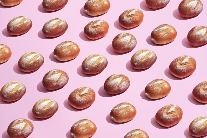 Bread rolls on a pink background