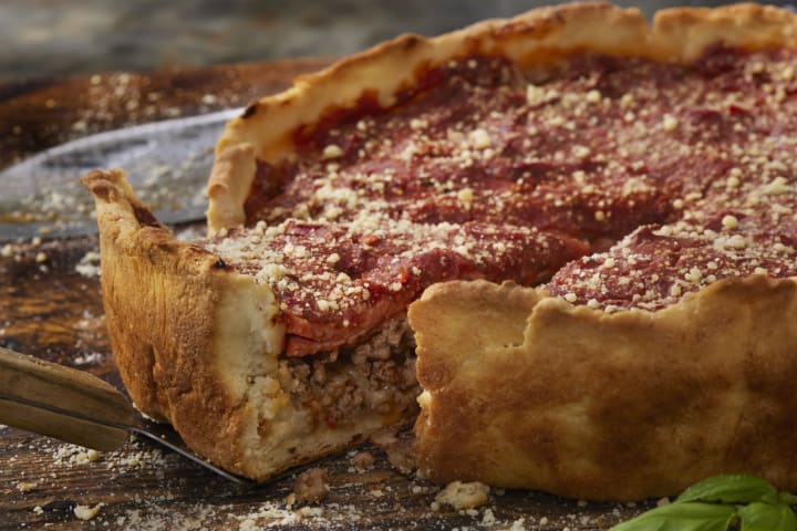 deep dish pizza with a slice pulled out