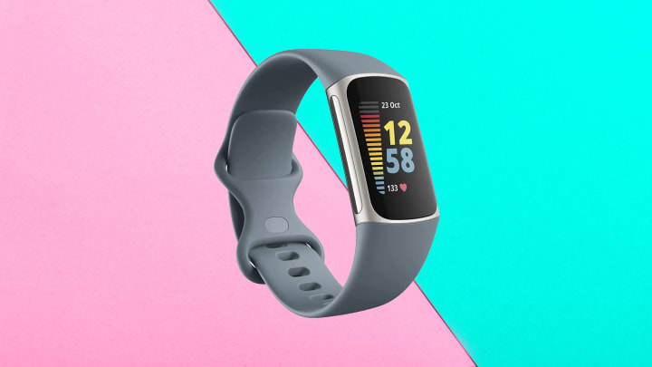 Fitbit Charge 5 Advanced Fitness Tracker against colorful background.
