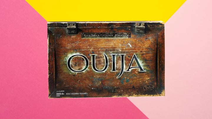 Hasbro Gaming Ouija Board Game against colorful background.