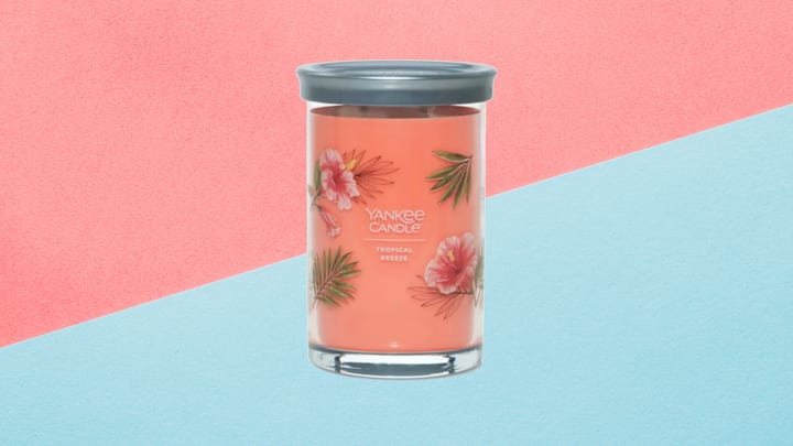 Yankee Candle Tropical Breeze Signature Collection 20-Ounce Large Tumbler Candle against pink and blue background.