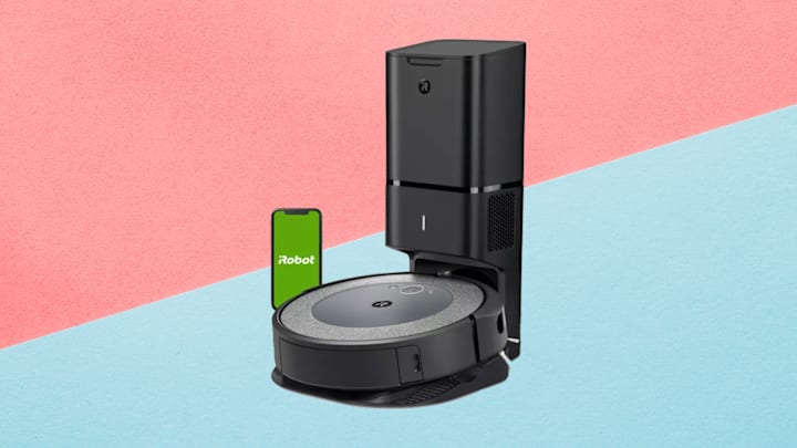 iRobot Roomba i3+ EVO (3550) Wi-Fi Connected Self-Emptying Robot Vacuum against a pink and blue background.
