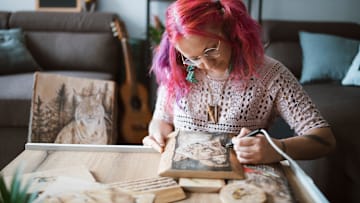 A southpaw works on a craft project.