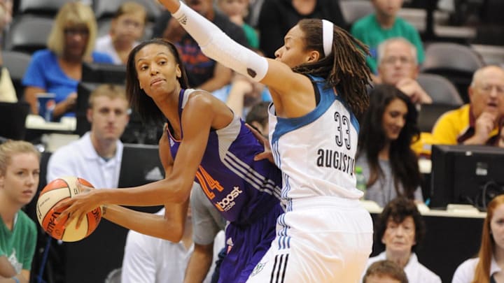 Jul 24, 2013; Minneapolis, MN, USA;  Phoenix Mercury guard DeWanna Bonner (24) looks to pass around Minnesota Score guard Seimone Augustus (33) in the first half at Target Center.  The Lynx defeated the Mercury 81-69.  Mandatory Credit: Marilyn Indahl-Imagn Images