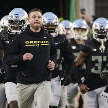 Nov 30, 2024; Eugene, Oregon, USA; Oregon Ducks head coach Dan Lanning runs out with the team before a game against the Washington Huskies at Autzen Stadium. Mandatory Credit: Troy Wayrynen-Imagn Images