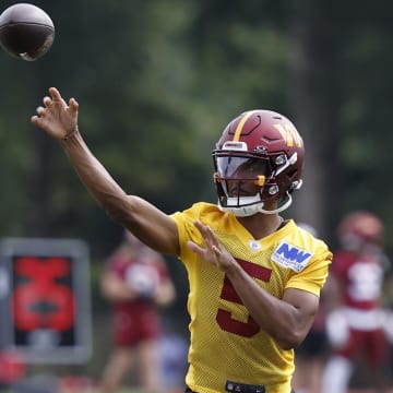 Jul 26, 2024; Ashburn, VA, USA; Washington Commanders quarterback Jayden Daniels (5) passes the ball on day three of training camp at Commanders Park. Mandatory Credit: Geoff Burke-USA TODAY Sports