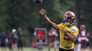 Jul 26, 2024; Ashburn, VA, USA; Washington Commanders quarterback Jayden Daniels (5) passes the ball on day three of training camp at Commanders Park. Mandatory Credit: Geoff Burke-USA TODAY Sports