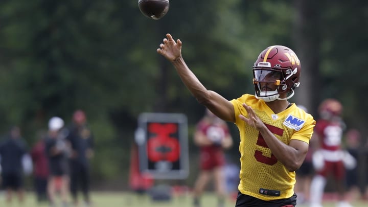 Jul 26, 2024; Ashburn, VA, USA; Washington Commanders quarterback Jayden Daniels (5) passes the ball on day three of training camp at Commanders Park. Mandatory Credit: Geoff Burke-USA TODAY Sports