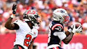 New England Patriots wide receiver Kyle Williams (18) runs for a gain past Tampa Bay Buccaneers cornerback Benjamin Morrison (21).