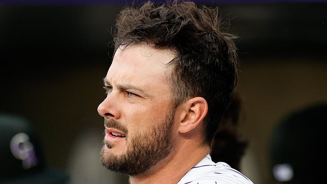 Colorado Rockies designated hitter Kris Bryant (23) looks on from the dugout