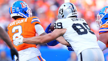 Oct 6, 2024; Denver, Colorado, USA; Denver Broncos cornerback Pat Surtain II (2) brings in a interception away from Las Vegas Raiders tight end Brock Bowers (89) in the fourth quarter at Empower Field at Mile High. Mandatory Credit: Ron Chenoy-Imagn Images