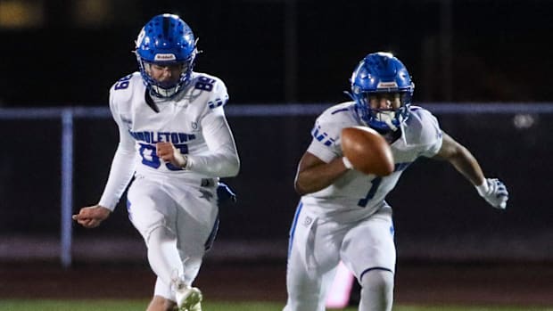 Middletown kicker Austin Hamm (left) puts the Cavaliers' second straight successful onside kick in play as Makai Walker cover