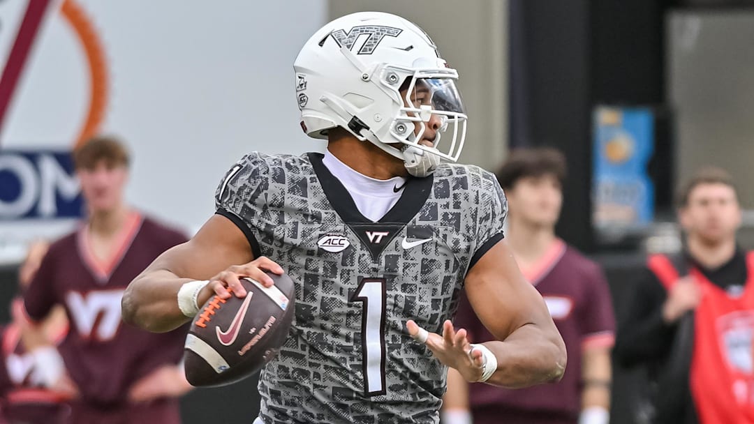 Nov 22, 2025; Blacksburg, Virginia, USA;  Virginia Tech Hokies quarterback Kyron Drones (1) looks to pass against the Miami (FL) Hurricanes during the fourth quarter at Lane Stadium. Mandatory Credit: Brian Bishop-Imagn Images