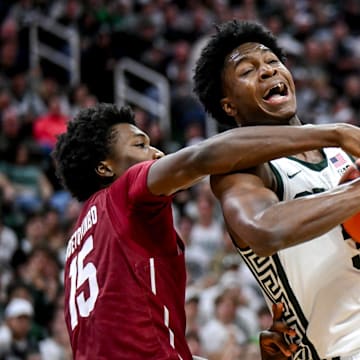 Michigan State's Cam Ward, right, is fouled by Colgate's Ayomi Odetoyinbo during the second half on Monday, Nov. 3, 2025, at the Breslin Center in East Lansing.