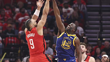 Apr 23, 2025; Houston, Texas, USA; Houston Rockets forward Dillon Brooks (9) shoots the ball over Golden State Warriors forward Draymond Green (23) during game two of the first round for the 2024 NBA Playoffs at Toyota Center. Mandatory Credit: Troy Taormina-Imagn Images