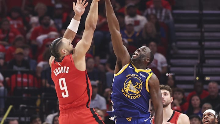 Apr 23, 2025; Houston, Texas, USA; Houston Rockets forward Dillon Brooks (9) shoots the ball over Golden State Warriors forward Draymond Green (23) during game two of the first round for the 2024 NBA Playoffs at Toyota Center. Mandatory Credit: Troy Taormina-Imagn Images