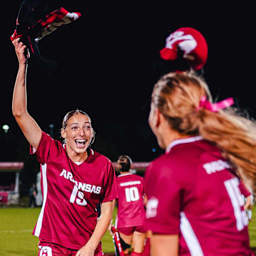 Arkansas soccer players celebrate against Alabama last week.
