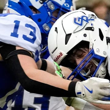 Remsen St. Mary's Dalton Klein (13) hits Gladbrook-Reinbeck’s Hudson Clark (3) during the Iowa high school 8-player championship Thursday, Nov. 21, 2024 at the UNI-Dome in Cedar Falls, Iowa.