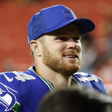 Nov 2, 2025; Landover, Maryland, USA; Seattle Seahawks quarterback Sam Darnold (14) smiles while leaving the field after the game against the Washington Commanders at Northwest Stadium.