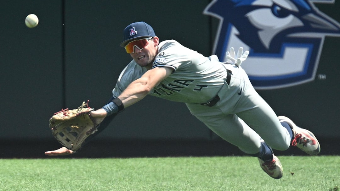 Jun 15, 2025; Omaha, Neb, USA;  Arizona Wildcats right fielder Brendan Summerhill (4) tries to dive for a catch against the Arizona Wildcats during the eighth inning at Charles Schwab Field. Mandatory Credit: Steven Branscombe-Imagn Images