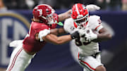 Dec 6, 2025; Atlanta, GA, USA; Georgia Bulldogs running back Chauncey Bowens (33) rushes as Alabama Crimson Tide linebacker Justin Hill (8) tackles during the second quarter during the 2025 SEC Championship game at Mercedes-Benz Stadium. Mandatory Credit: Brett Davis-Imagn Images