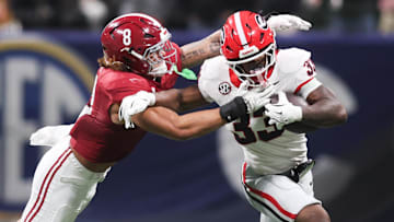 Dec 6, 2025; Atlanta, GA, USA; Georgia Bulldogs running back Chauncey Bowens (33) rushes as Alabama Crimson Tide linebacker Justin Hill (8) tackles during the second quarter during the 2025 SEC Championship game at Mercedes-Benz Stadium. Mandatory Credit: Brett Davis-Imagn Images