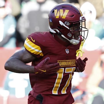 Dec 22, 2024; Landover, Maryland, USA; Washington Commanders wide receiver Terry McLaurin (17) celebrates after catching a touchdown pass against the Philadelphia Eagles during the second quarter at Northwest Stadium. Mandatory Credit: Geoff Burke-Imagn Images