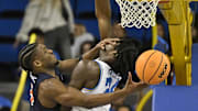 Nov 22, 2024; Los Angeles, California, USA; Cal State Fullerton Titans guard Donovan Oday (5) collides with UCLA Bruins forward William Kyle III (24) during the second half at Pauley Pavilion presented by Wescom. Mandatory Credit: Robert Hanashiro-Imagn Images