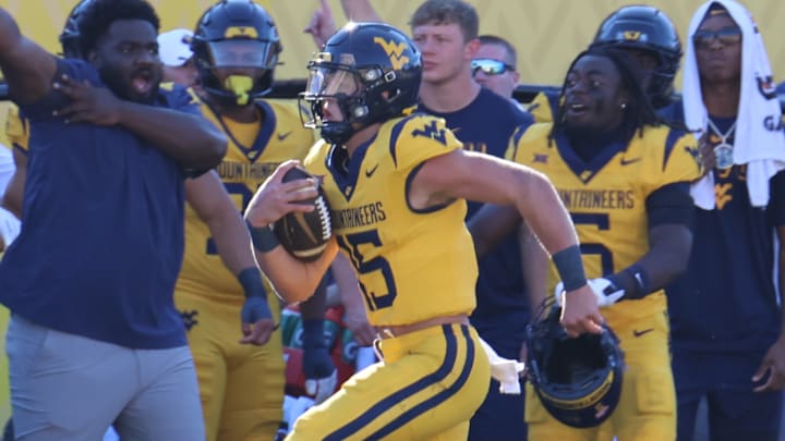 West Virginia University quarterback Scotty Fox Jr. races down the sideline for a 59-yard touchdown run.