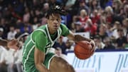 Jan 28, 2024; Boca Raton, Florida, USA; North Texas Mean Green forward Aaron Scott (1) dribbles the basket as Florida Atlantic Owls guard Johnell Davis (1) defends during the first half at Eleanor R. Baldwin Arena. Mandatory Credit: Sam Navarro-Imagn Images