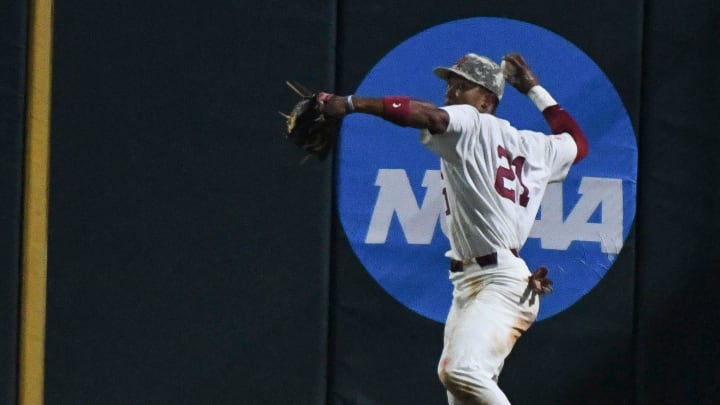 Alabama outfielder Andrew Pinckney (21) fields the ball in the right field corner then guns the Nicholls batter who tried to stretch a single into a double at Sewell-Thomas Stadium in Tuscaloosa, Ala., Friday June 2, 2023, in the first round of the NCAA Regional Baseball Tournament.