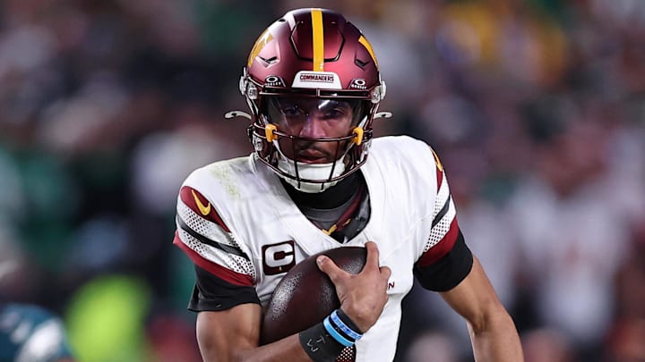 Washington Commanders quarterback Jayden Daniels runs with the ball against the Philadelphia Eagles.