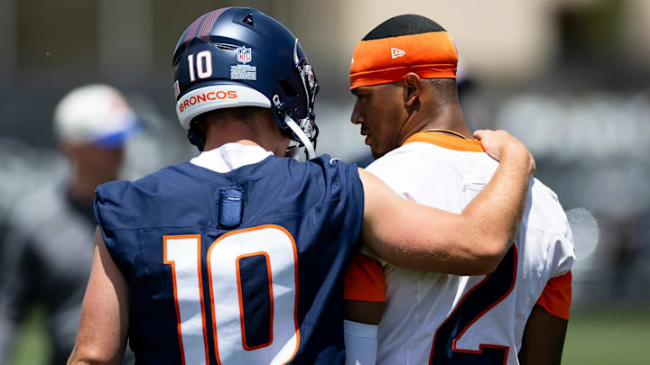 Denver Broncos quarterback Bo Nix (10) puts his arm around cornerback Patrick Surtain II (2) during mandatory minicamp.
