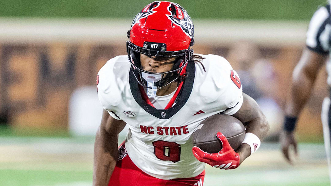 Sep 11, 2025; Winston-Salem, North Carolina, USA;  North Carolina State Wolfpack wide receiver Keenan Jackson (8) runs past Wake Forest Demon Deacons defensive back Nick Andersen (45) in the second half at Allegacy Federal Credit Union Stadium. Mandatory Credit: Luke Jamroz-Imagn Images