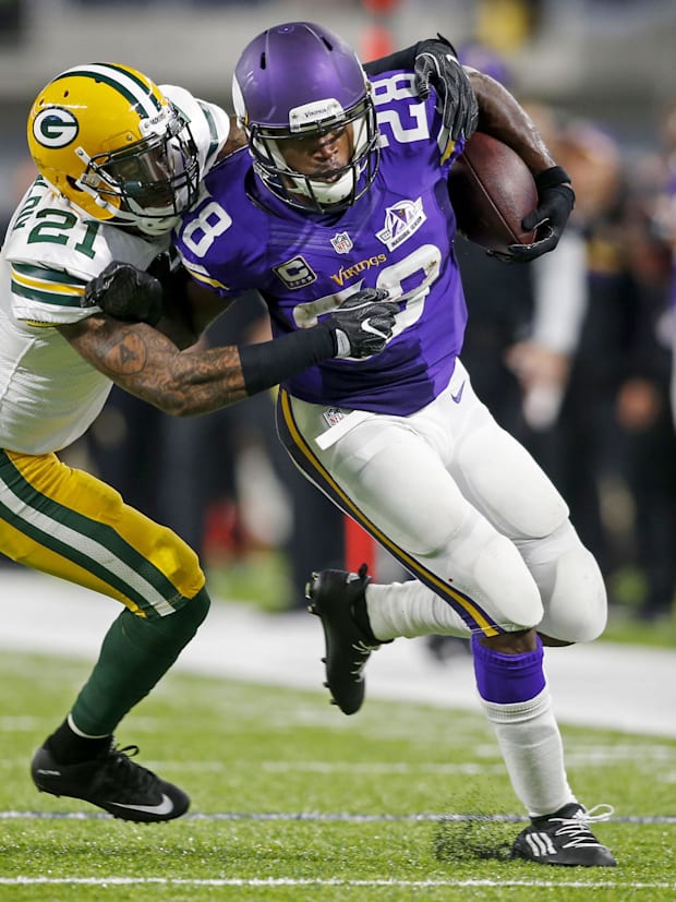 Green Bay Packers safety Ha Ha Clinton-Dix tackles Minnesota Vikings running back Adrian Peterson.
