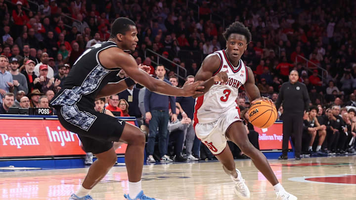 Mar 3, 2026; New York, New York, USA;  St. John's Red Storm guard Joson Sanon (3) drives past Georgetown Hoyas center Vincent Iwuchukwu (3) in the second half at Madison Square Garden.