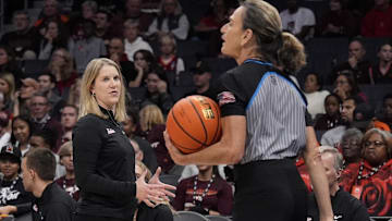 Nov 10, 2024; Charlotte, NC, USA; Virginia Tech Hokies head coach Megan Duffy talks to the official during the first half against the Iowa Hawkeyes at Spectrum Center. Mandatory Credit: Jim Dedmon-Imagn Images