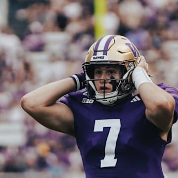 Will Rogers strains to hear the UW coaches over his headset. 