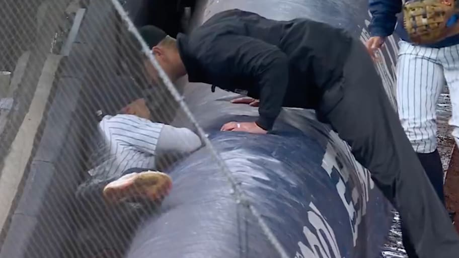 An umpire checks on Oswald Peraza after he made a tough catch. | @Yankees