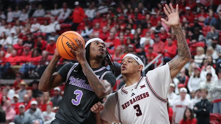 Feb 21, 2026; Lubbock, Texas, USA;   Kansas State Wildcats guard C.J. Jones (3) goes to the basket against Texas Tech Red Raiders forward LeJuan Watts (3) in the second half at United Supermarkets Arena.